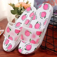 White peach-print slide sandals with open toe, front strap, and cushioned sole