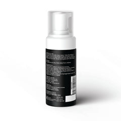 White foaming pump bottle showing back label of men's intimate wash with instructions and ingredients list