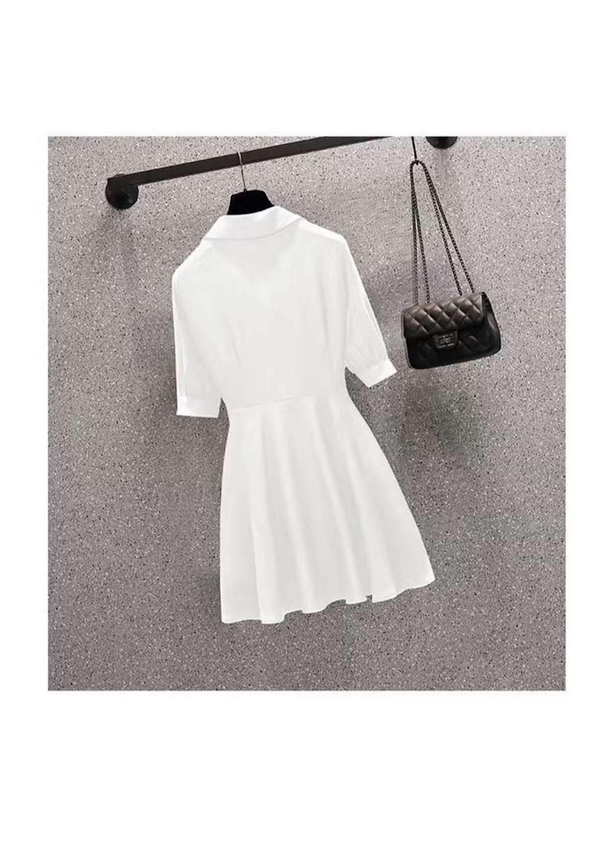 White slim fit plus size long sleeve top dress hanging on black hanger with quilted black purse