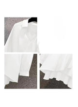 White long sleeve top with tiered hem and V-neck, belt at waist