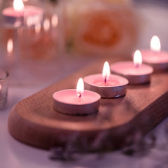 Huitich flameless smokeless tea light candles glowing softly on a wooden tray