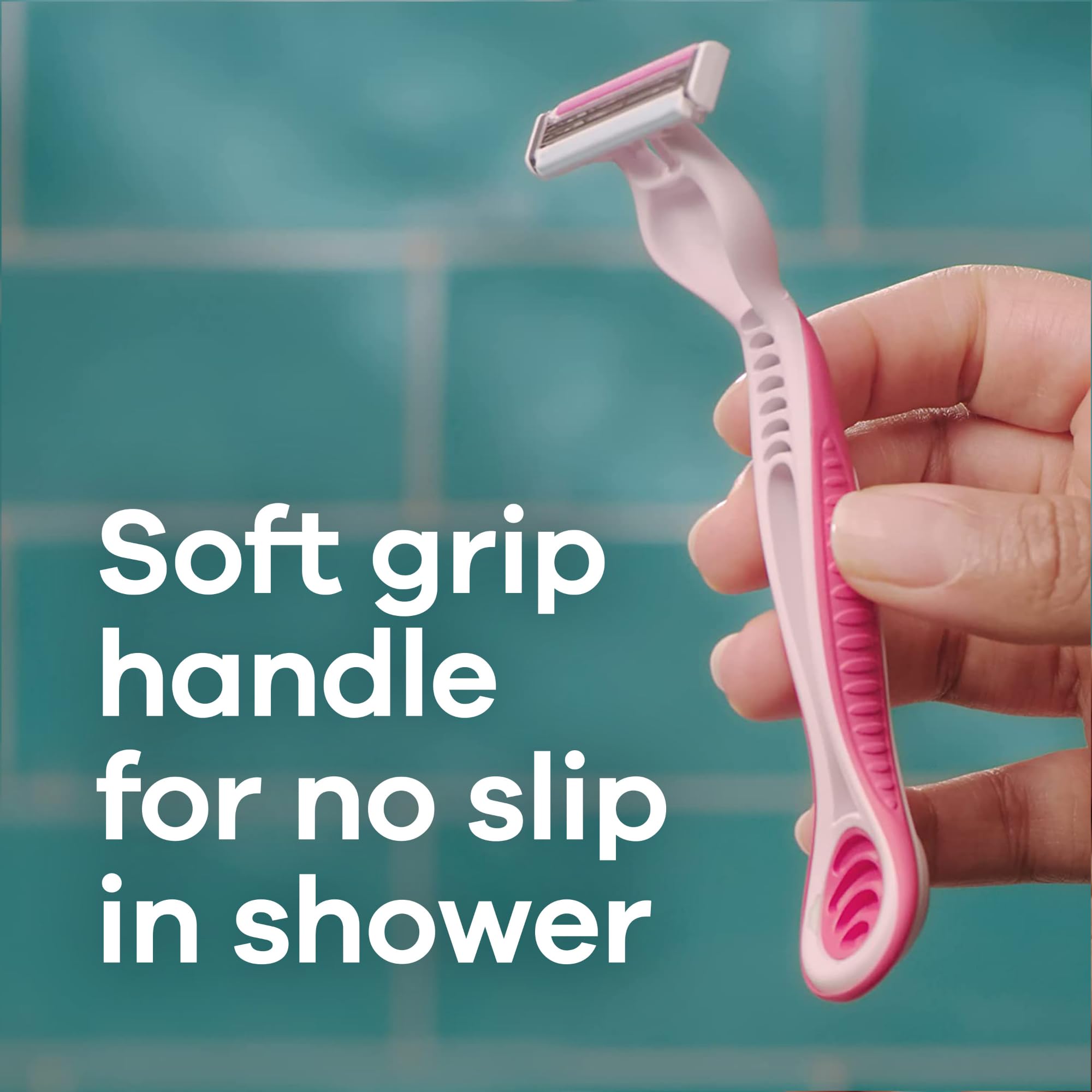 Venus pink razor with soft non slip grip held in hand over shower tiles women's disposable razors for sensitive skin