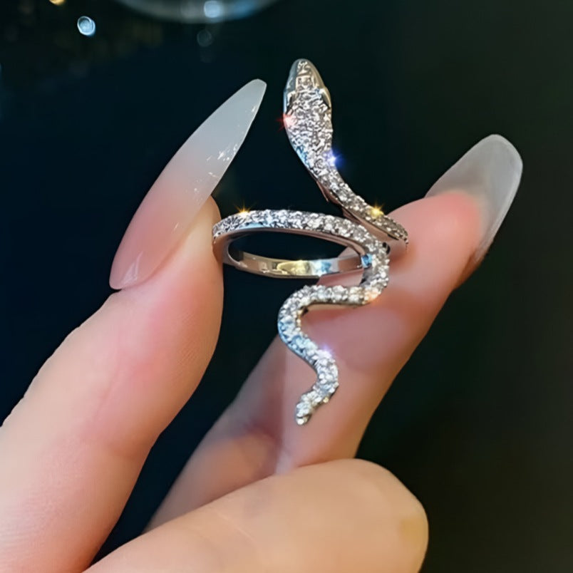 Huitich snake design ring silver with sparkling details held between fingers