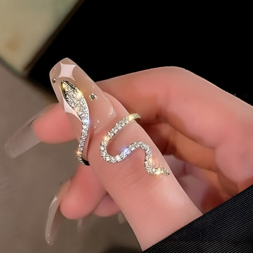 Huitich snake design ring silver with sparkling stones worn on a finger with glossy nude nails