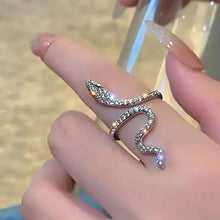 Silver snake ring with sparkling pavé stones and a curved, open silhouette
