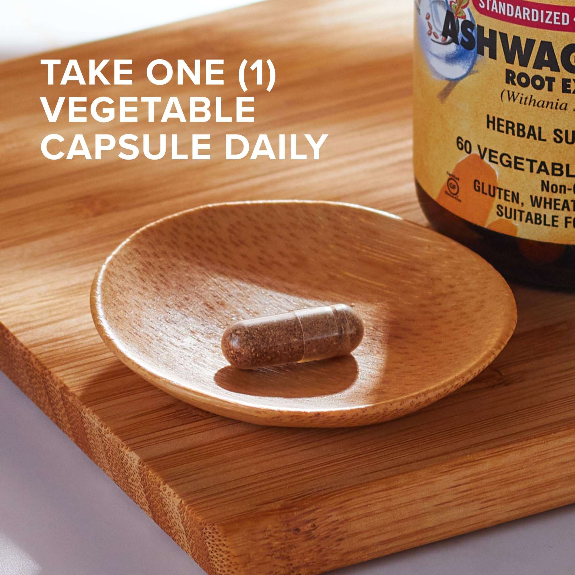 Solgar bottle and single vegetable capsule on wooden dish with instruction text showing ashwagandha root extract capsules