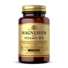 Amber glass bottle of Solgar Magnesium with Vitamin B6 tablets. Gold label shows 100 tablets dietary supplement