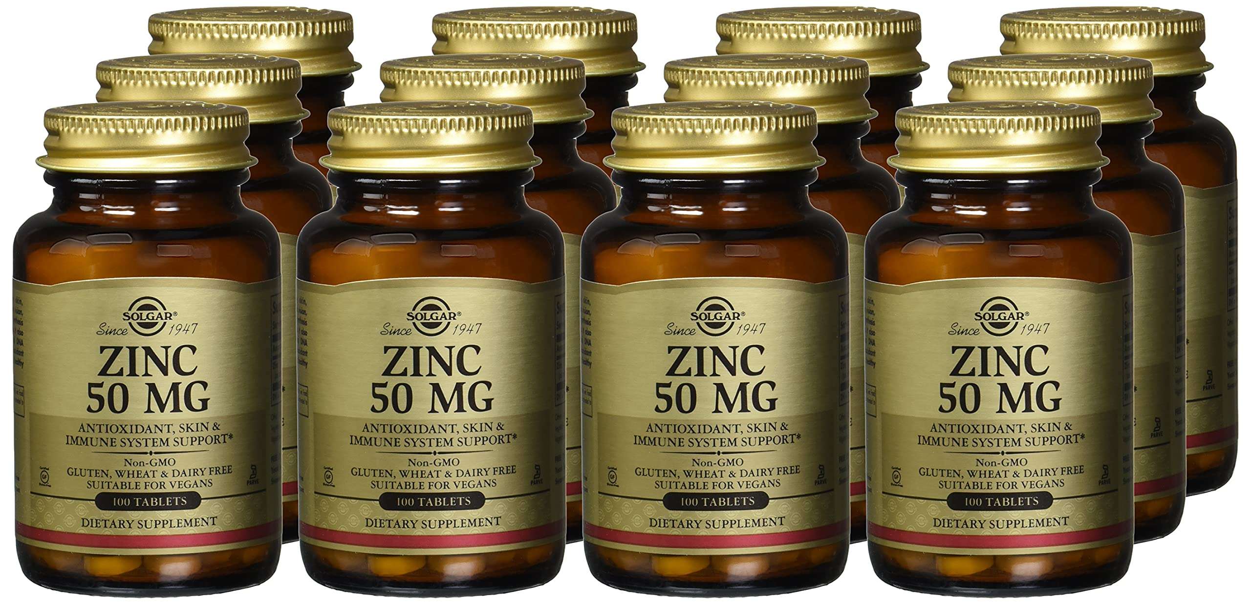 Multiple amber glass bottles of Solgar zinc tablets 50mg dietary supplement with gold caps