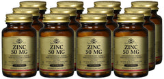 Multiple amber glass bottles of Solgar zinc tablets 50mg dietary supplement with gold caps