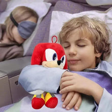 Knuckles plush doll held by a child, red hood and white face with blue eyes