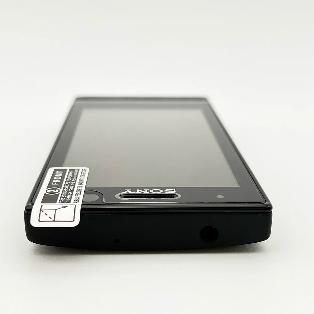 Sony Xperia U ST25i unlocked smartphone black front view lying flat with screen protector and Sony logo