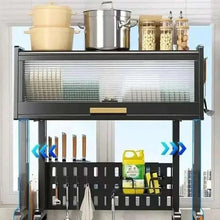 Black sink rack front with ribbed dish rack cover, cookware on top, utensil hooks