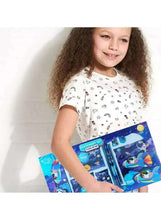 Kids blue space stationery set as a child holds the box with space penguin graphics