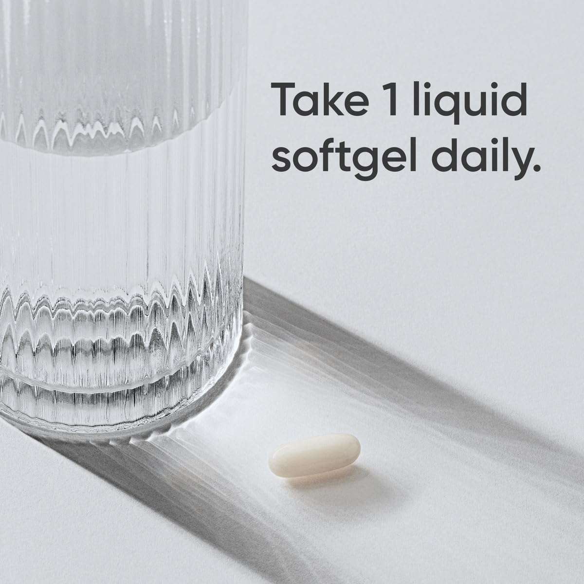 Sports Research L-theanine softgels single white liquid softgel beside glass with dosing text Take 1 daily for calm focus
