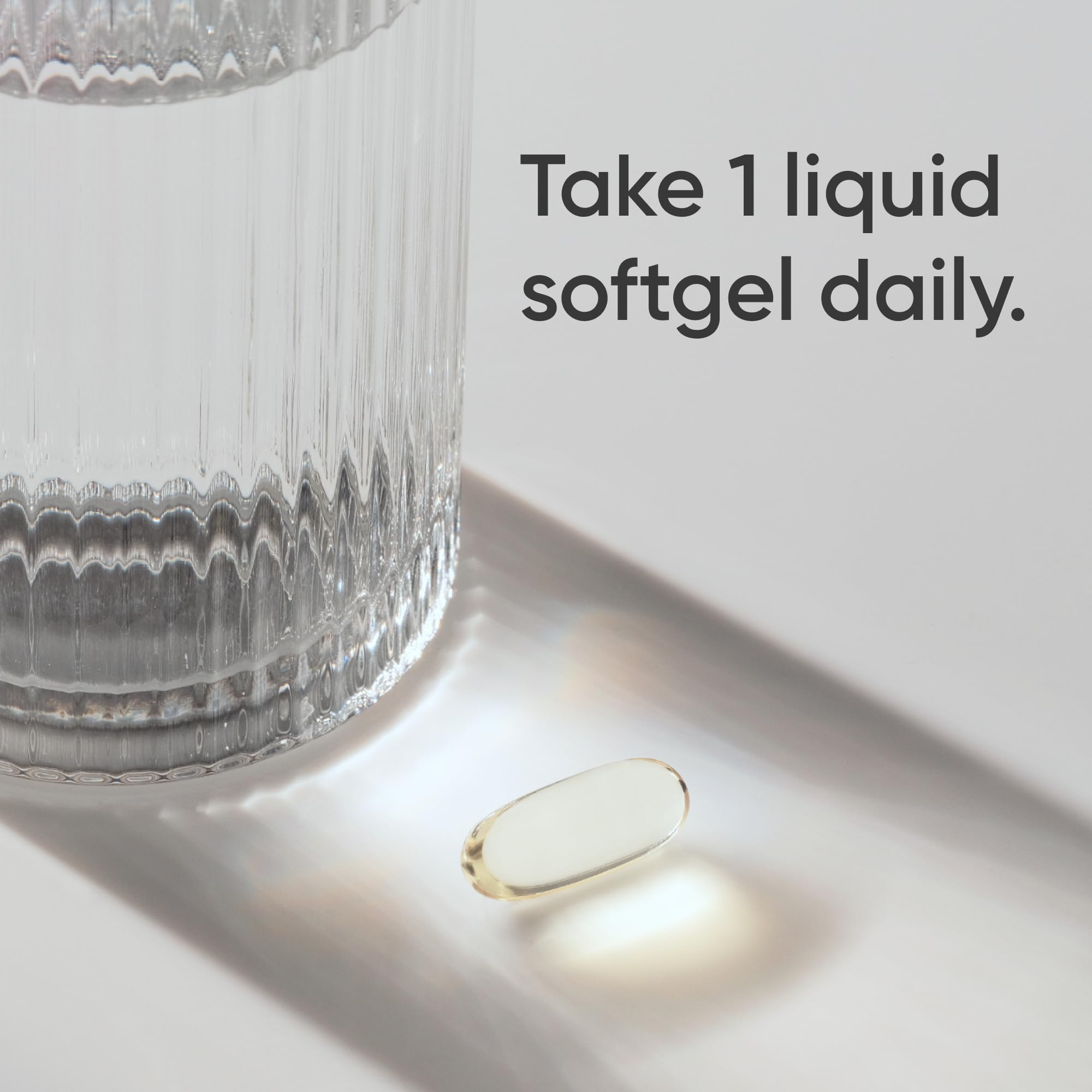 Sports Research triple strength omega 3 fish oil single liquid softgel beside glass of water daily dose