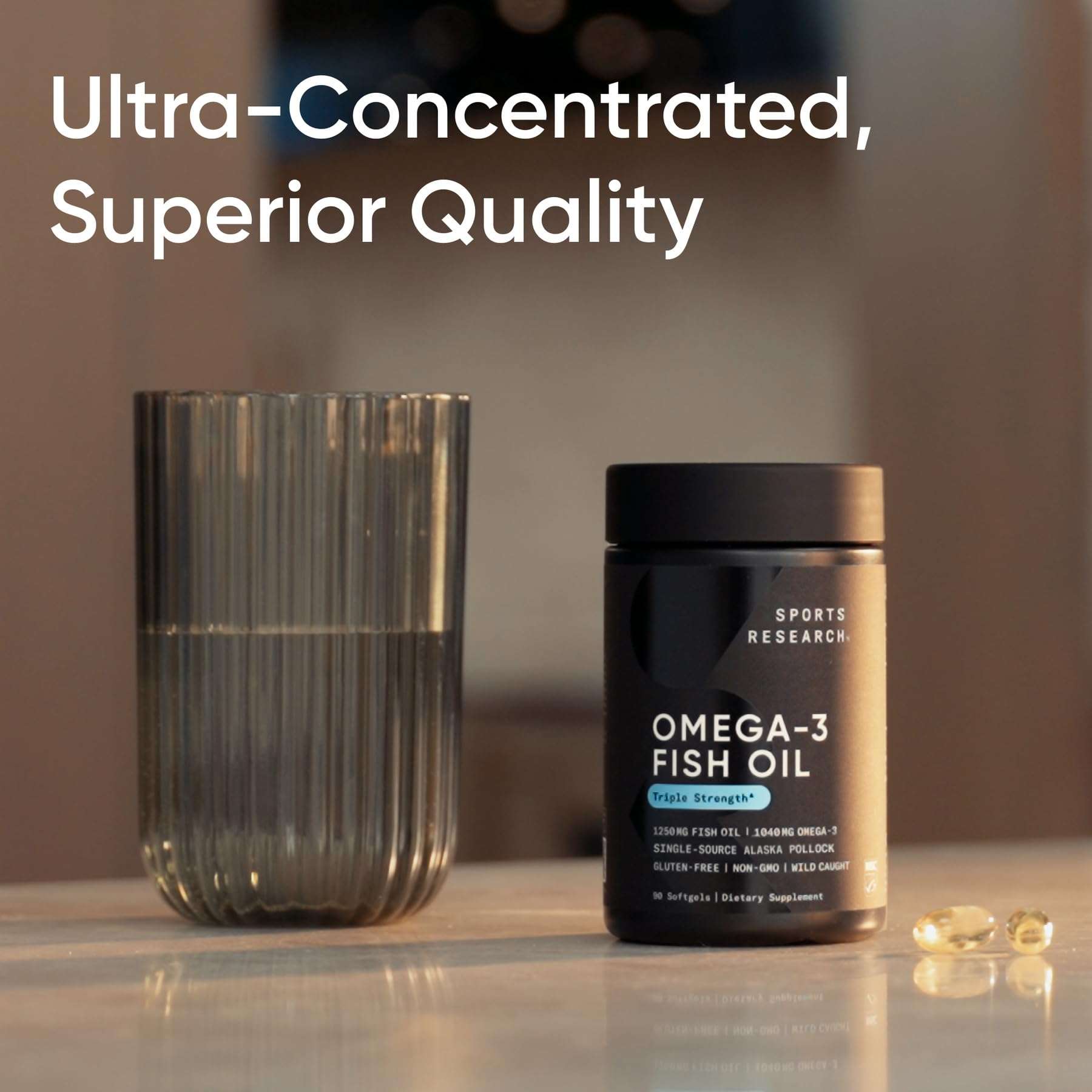 Sports Research bottle of triple strength omega 3 fish oil supplement next to glass of water and softgels