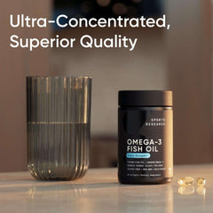 Sports Research bottle of triple strength omega 3 fish oil supplement next to glass of water and softgels