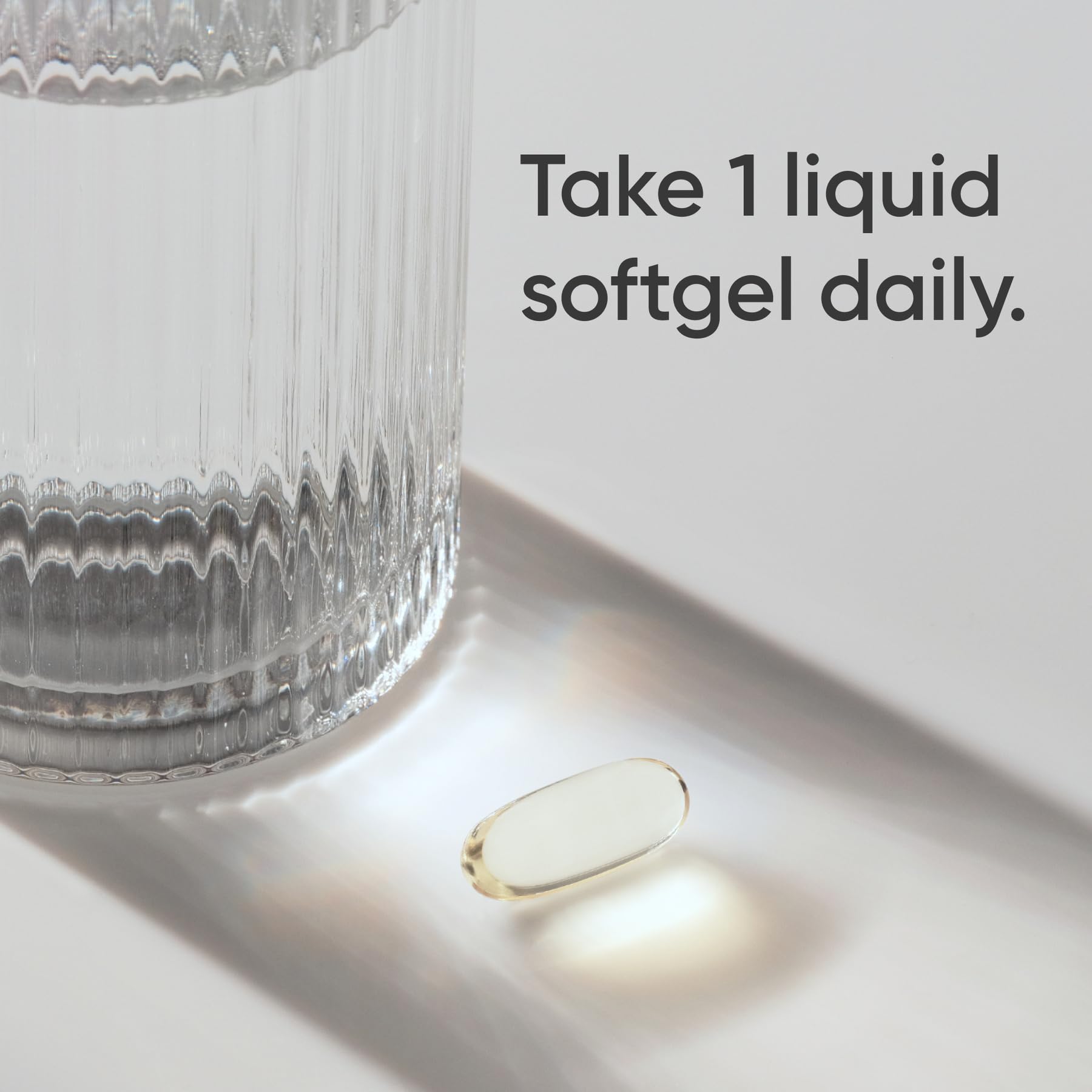 Sports Research triple strength omega 3 fish oil supplement single liquid softgel beside glass of water and dosage text