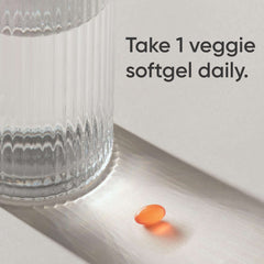 Orange veggie softgel next to glass of water with dosing text Vitamin K2 D3 supplement UAE by Sports Research