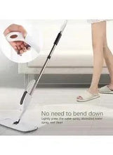 Spray mop with white-and-black handle and square microfiber pad on floor