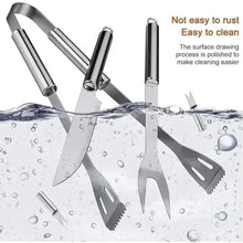 Stainless steel BBQ utensils set with spatula, fork, and tongs over water droplets