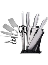 Stainless steel knife set with black-handled knives in a countertop stand