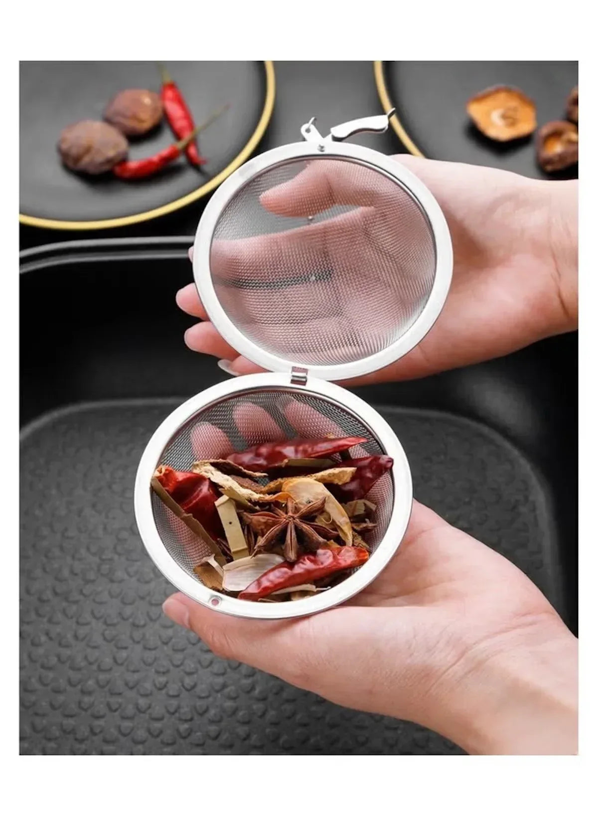 stainless-steel-tea-infuser-ball-with-spices-in-hand -- Mumzar