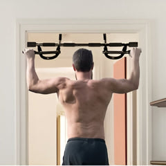 Man using Huitich steel push up bars mounted on a doorframe for upper body workout