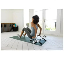 Steel push-up bars set with black grips and wide stance feet on mat