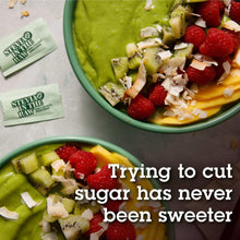 Stevia sugar substitute packets near a fruit bowl for mixing
