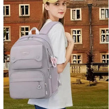 Kids school backpack on model, light gray front pockets, side zip, padded shoulder straps