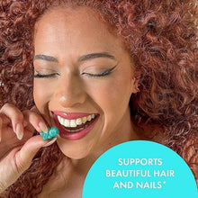 Woman smiling and biting a teal gummy; overlay says supports beautiful hair and nails