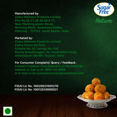 Sugar Free Natura product label showing company details and a silver plate of Indian ladoos sugar free sweetener drops