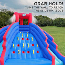 Inflatable bounce house climbing wall and slide area, blue with red frame and yellow targets.