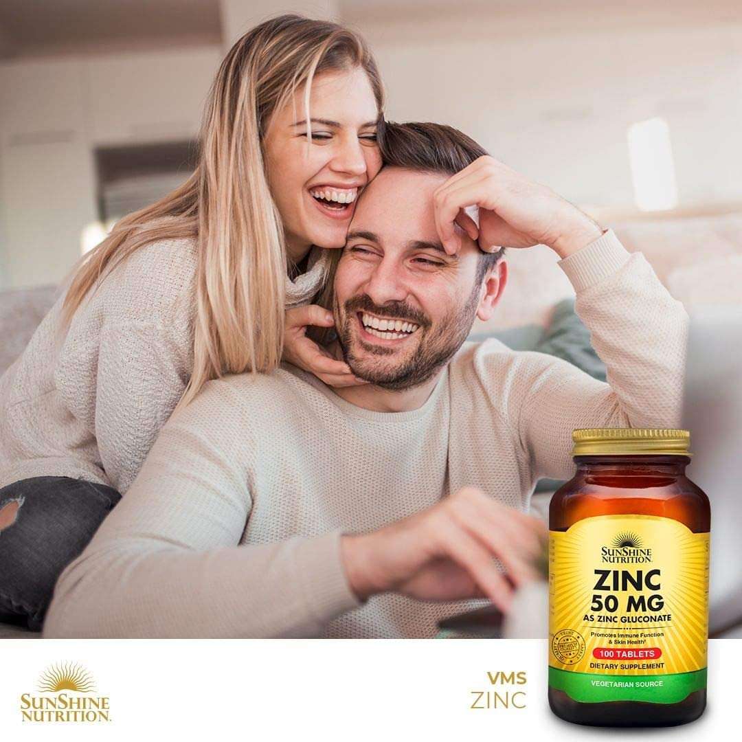 Sunshine Nutrition bottle of zinc 50 mg tablets beside smiling couple at home promoting immune support