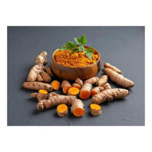 Turmeric powder in a wooden bowl with fresh turmeric roots and slices