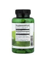 Ashwagandha supplement bottle with black cap and green capsules, Supplement Facts label