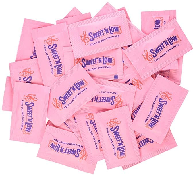 Pile of Sweet N Low pink single serve packets showing Sucralose zero calorie sweetener