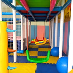 Colorful indoor swing playsets for backyard with red and green swings on padded floor