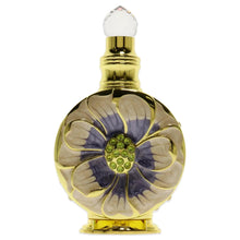 Eau de parfum bottle with gold cap and clear glass flower design, green center