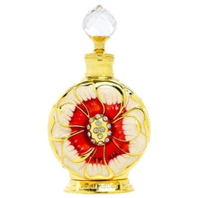 Concentrated perfume oil bottle with clear faceted cap and red floral emblem