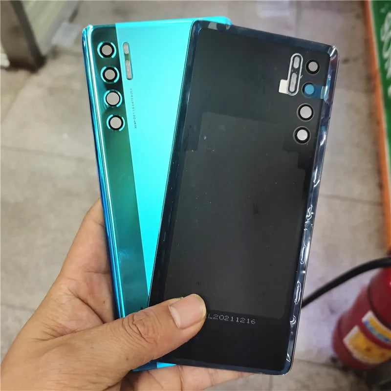 TCL 20 Pro 5G back cover replacement in teal and black shown held by hand with camera cutouts and glossy finish