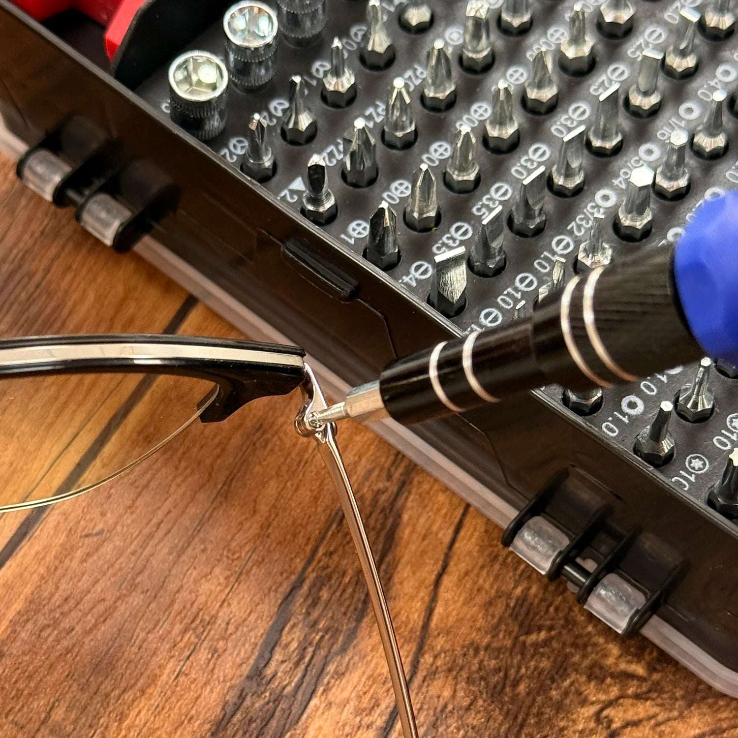 precision screwdriver set for electronics with assorted bits in case used to tighten eyeglass screw