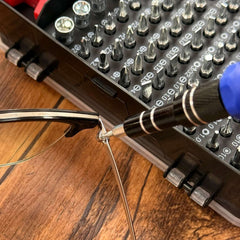 precision screwdriver set for electronics with assorted bits in case used to tighten eyeglass screw