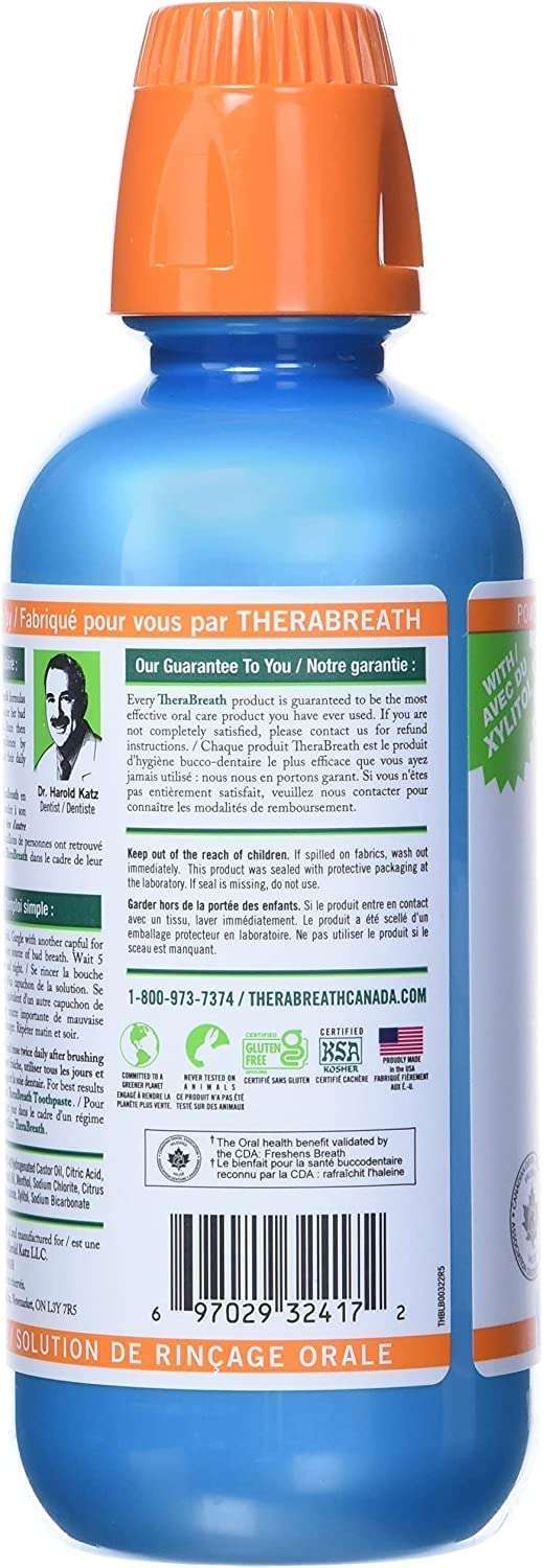 Back of blue bottle with orange cap and label showing ingredients directions and barcode TheraBreath fresh breath oral rinse