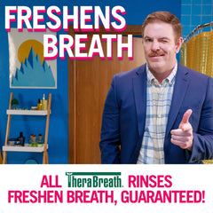 Man winking and pointing in a colorful bathroom ad for TheraBreath oral rinse for bad breath. Freshens Breath signage