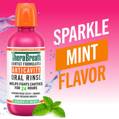 TheraBreath oral rinse for bad breath Sparkle Mint anticavity fluoride bottle with mint leaves and bright pink background