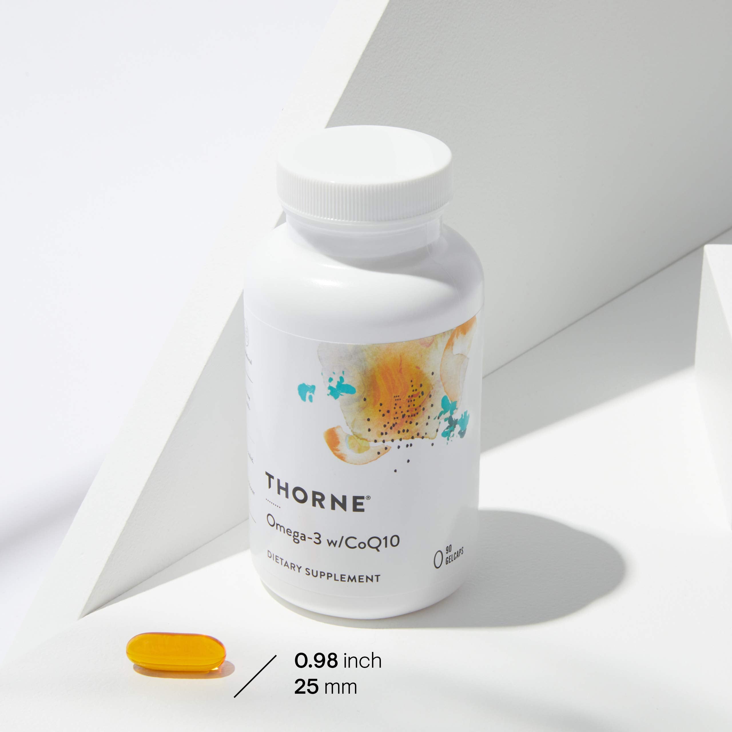 THORNE white bottle with abstract label and single yellow softgel on white background Omega-3 with CoQ10 supplement