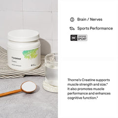 Jar of Thorne creatine monohydrate powder. White supplement tub with scoop of powder and glass of water