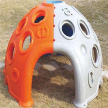 Orange and white plastic toddler play dome with circular openings and climbing footholds